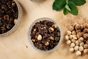 A bowl of Just So Good’s Mint-Chocolate-Chip granola, with oats, raw cacao, raw chocolate nibs, seeds and hazelnuts. Made with organic virgin olive oil and peppermint. Vegan, low sugar, plant based, low inflammatory breakfast. 